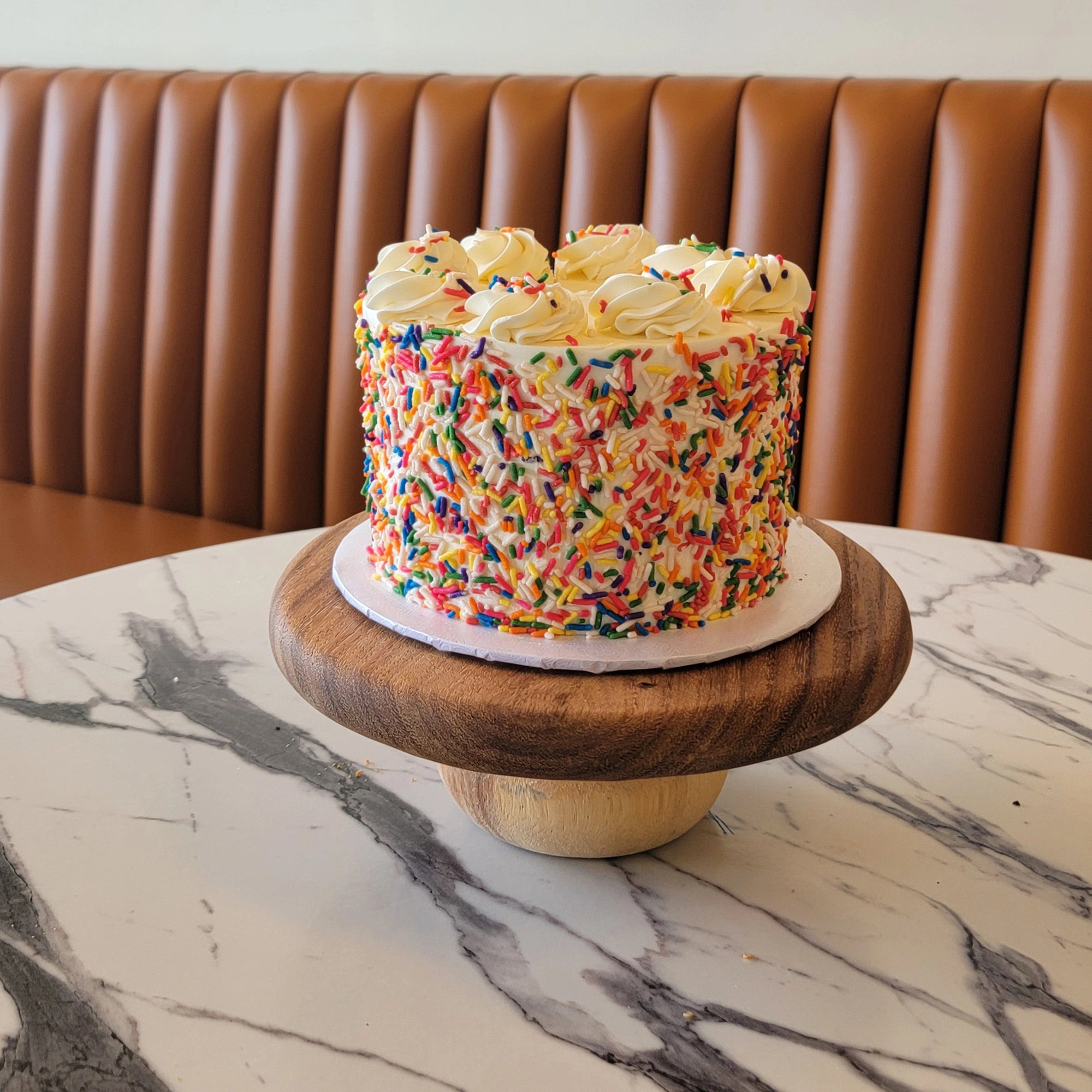 Classic Birthday Cake with white buttercream and colorful sprinkles