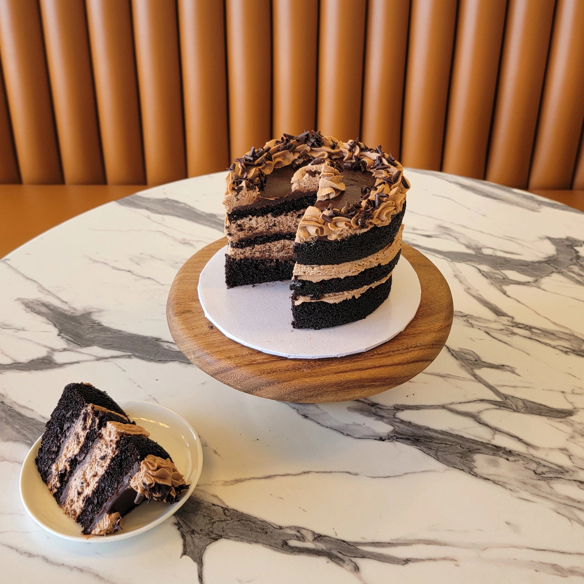 Chocolate Mousse Cake topped with mousse swirls, ganache, and chocolate curls