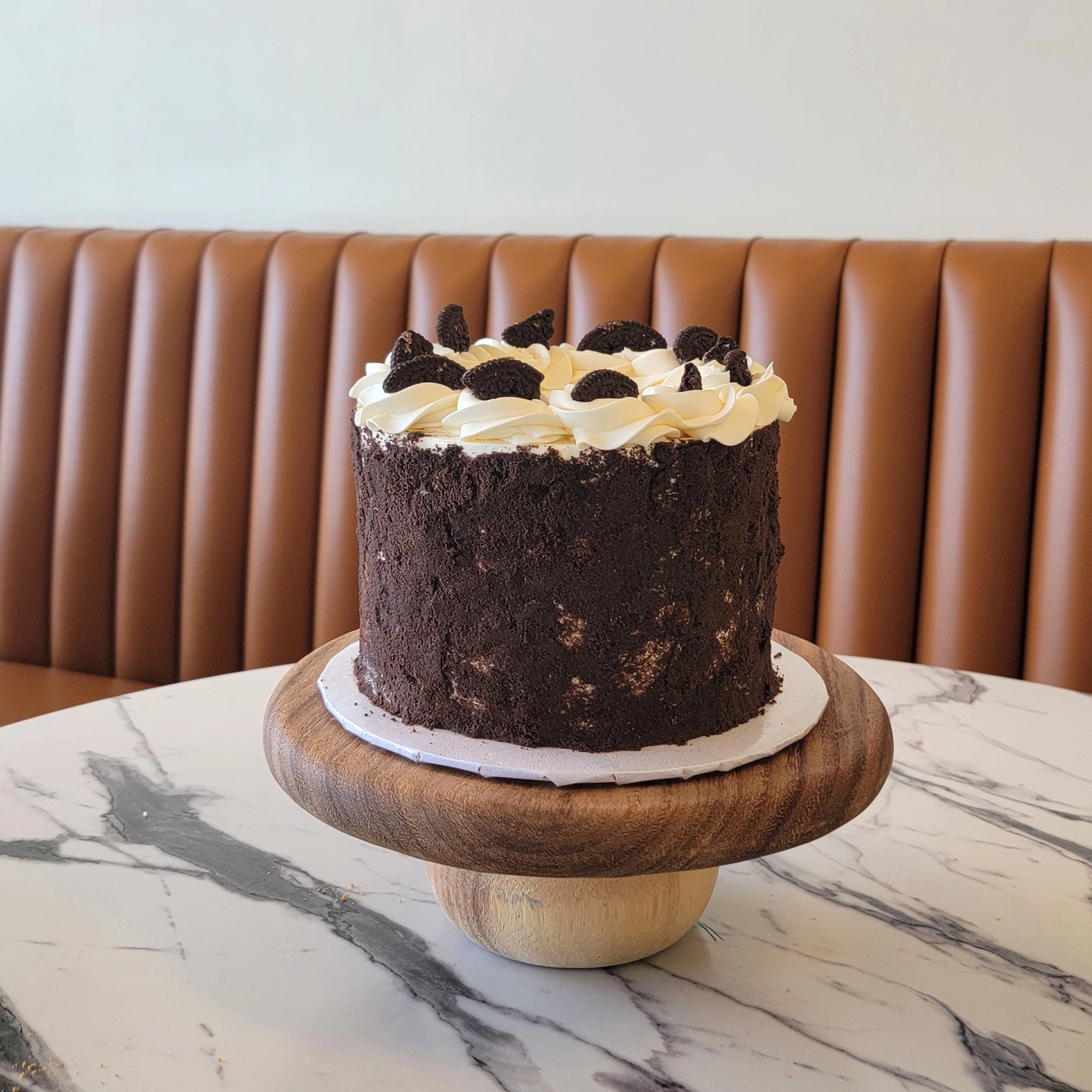 Oreo Cake with white buttercream and crushed Oreo cookie topping